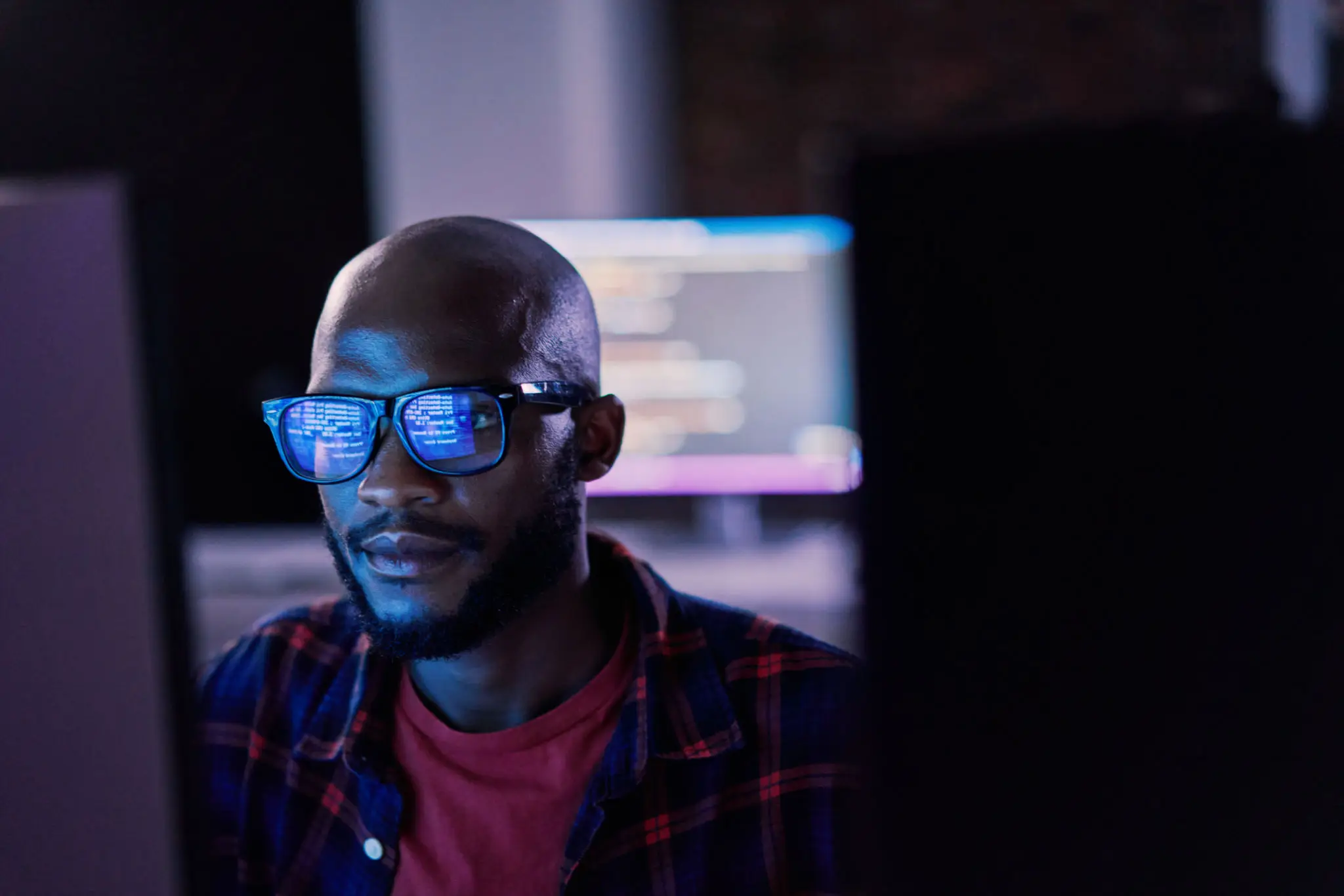 Developer with code reflected in glasses