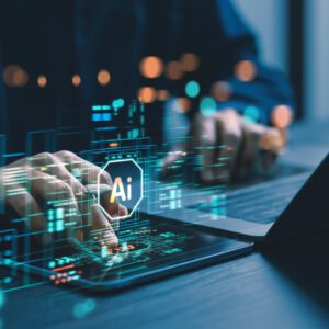 Hands typing on laptop with AI graphics