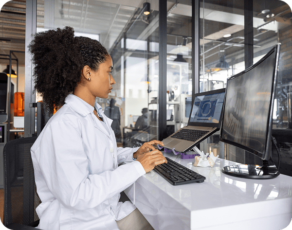Woman in lab coat using computer
