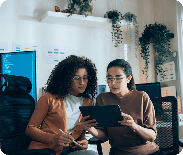 Two women collaborating on a tablet
