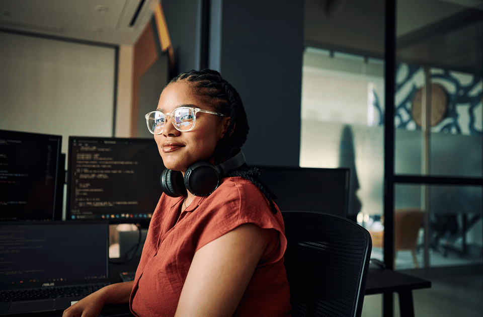 Programmer with headphones at desk