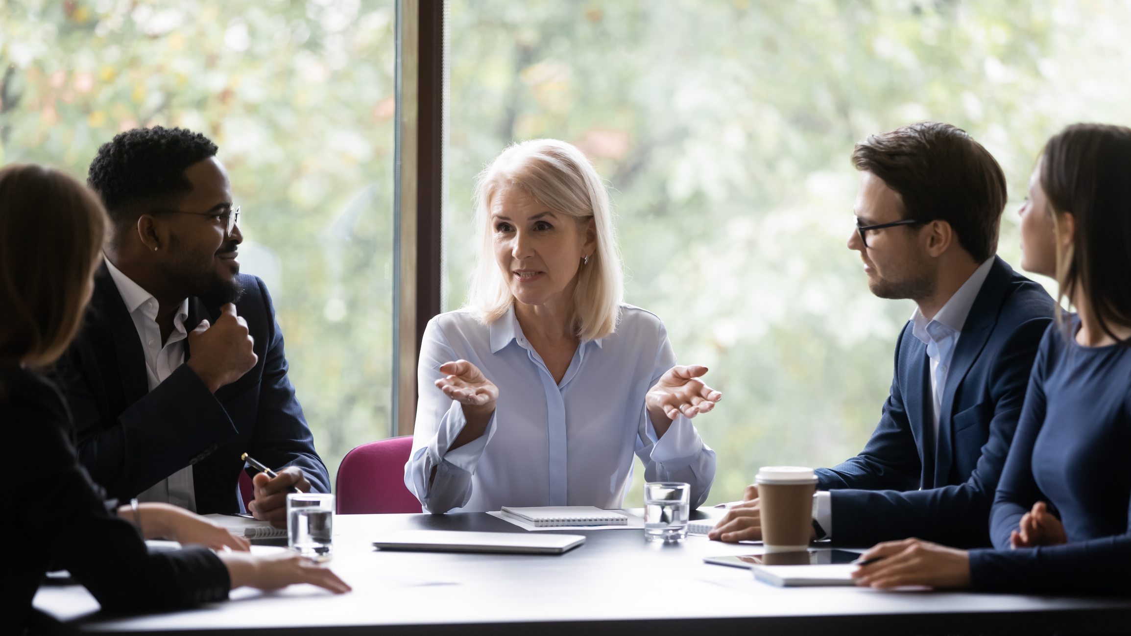 Business team meeting with professionals around table