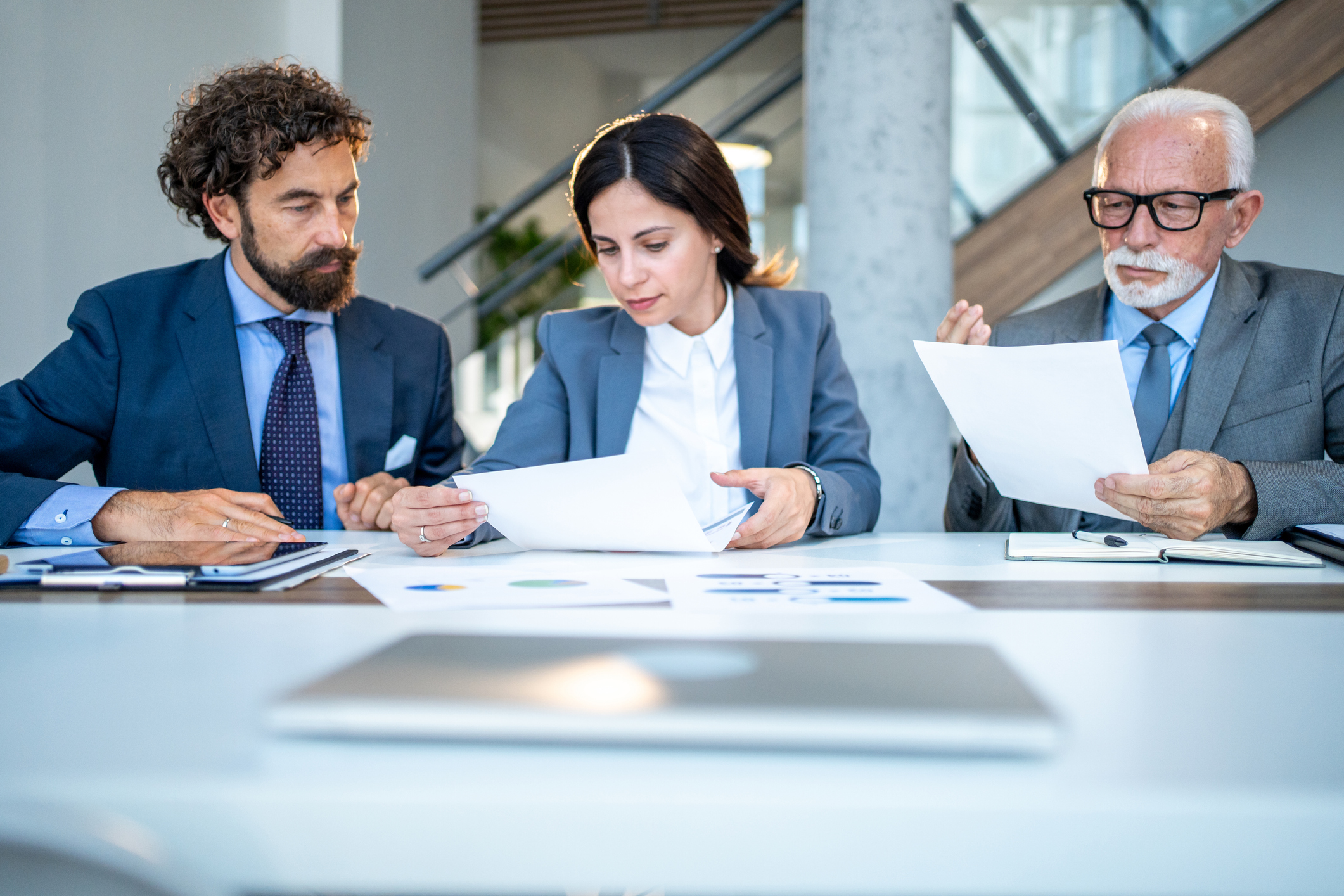 Business team reviewing documents at meeting table