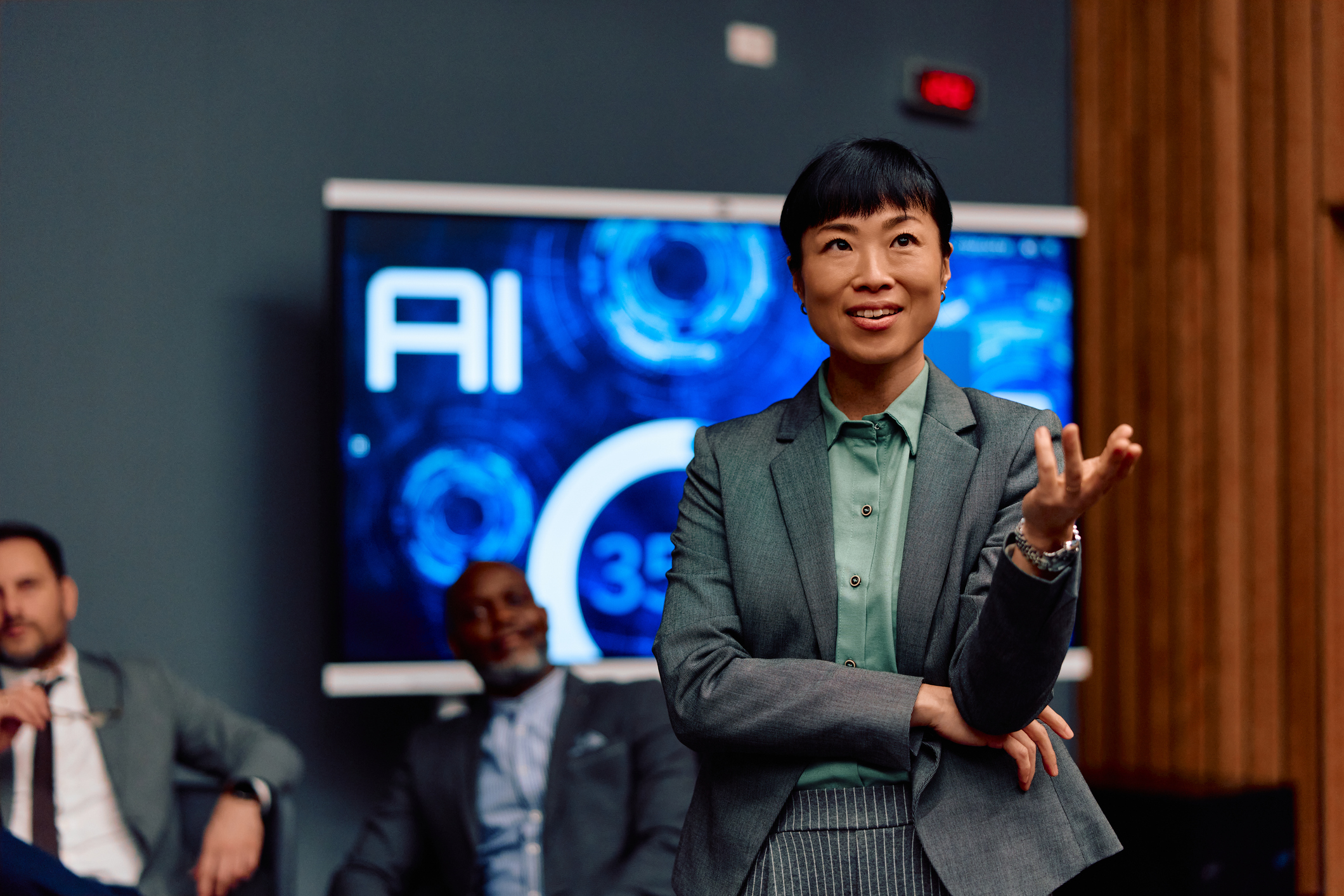 Businesswoman presenting AI slide to audience